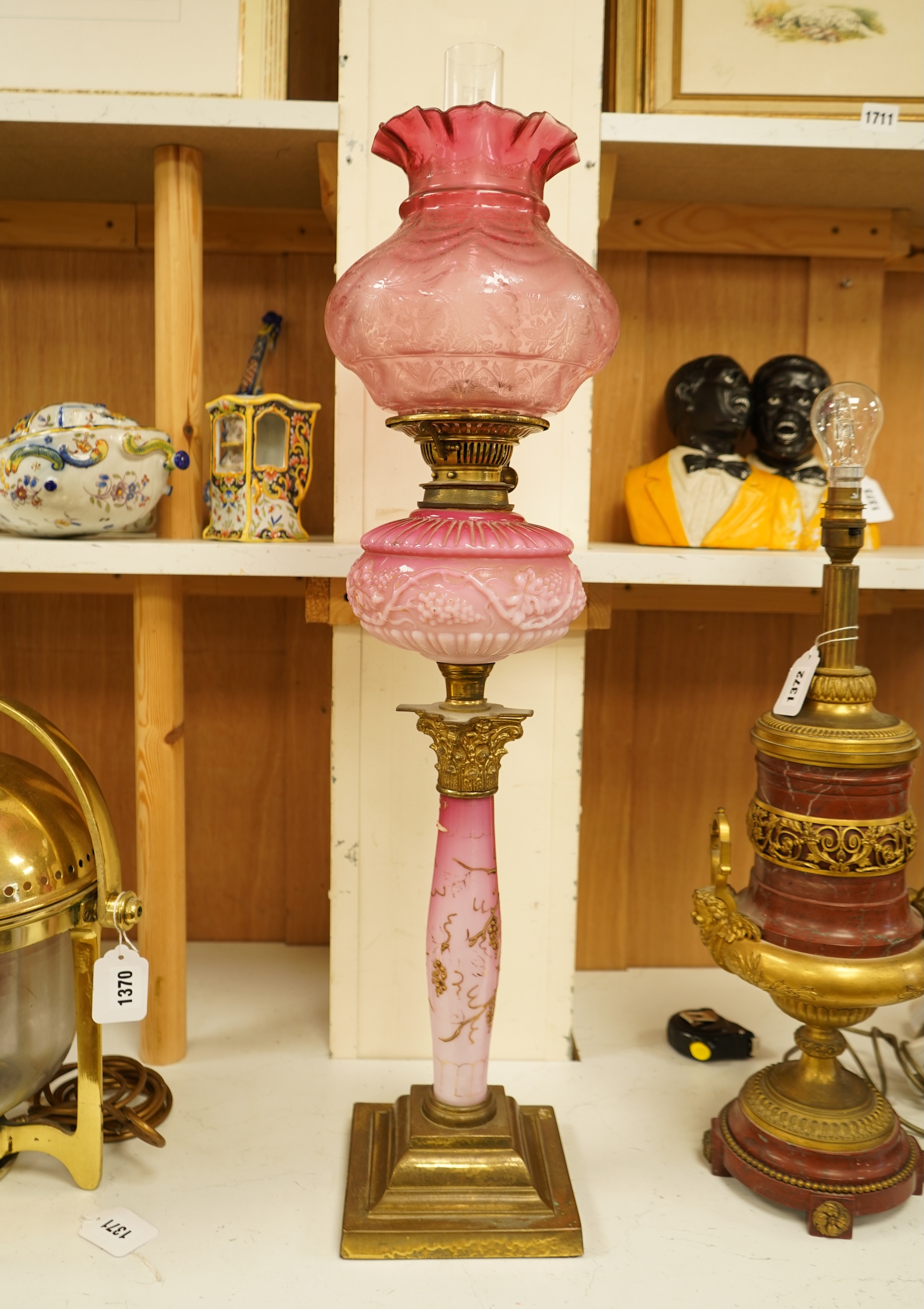 A Victorian brass and ruby glass oil lamp, 80cm high overall